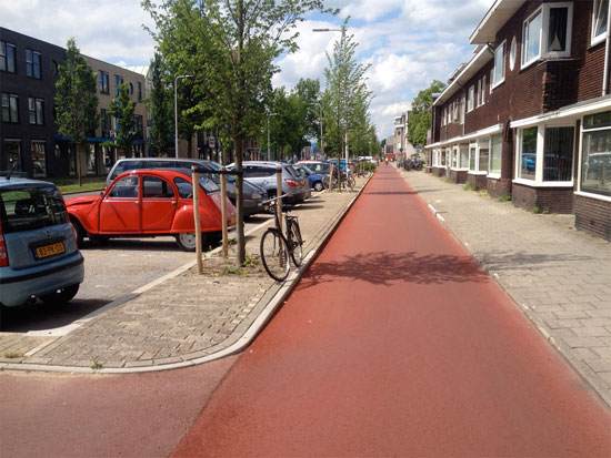 The smooth red asphalt of a Dutch cycleway.